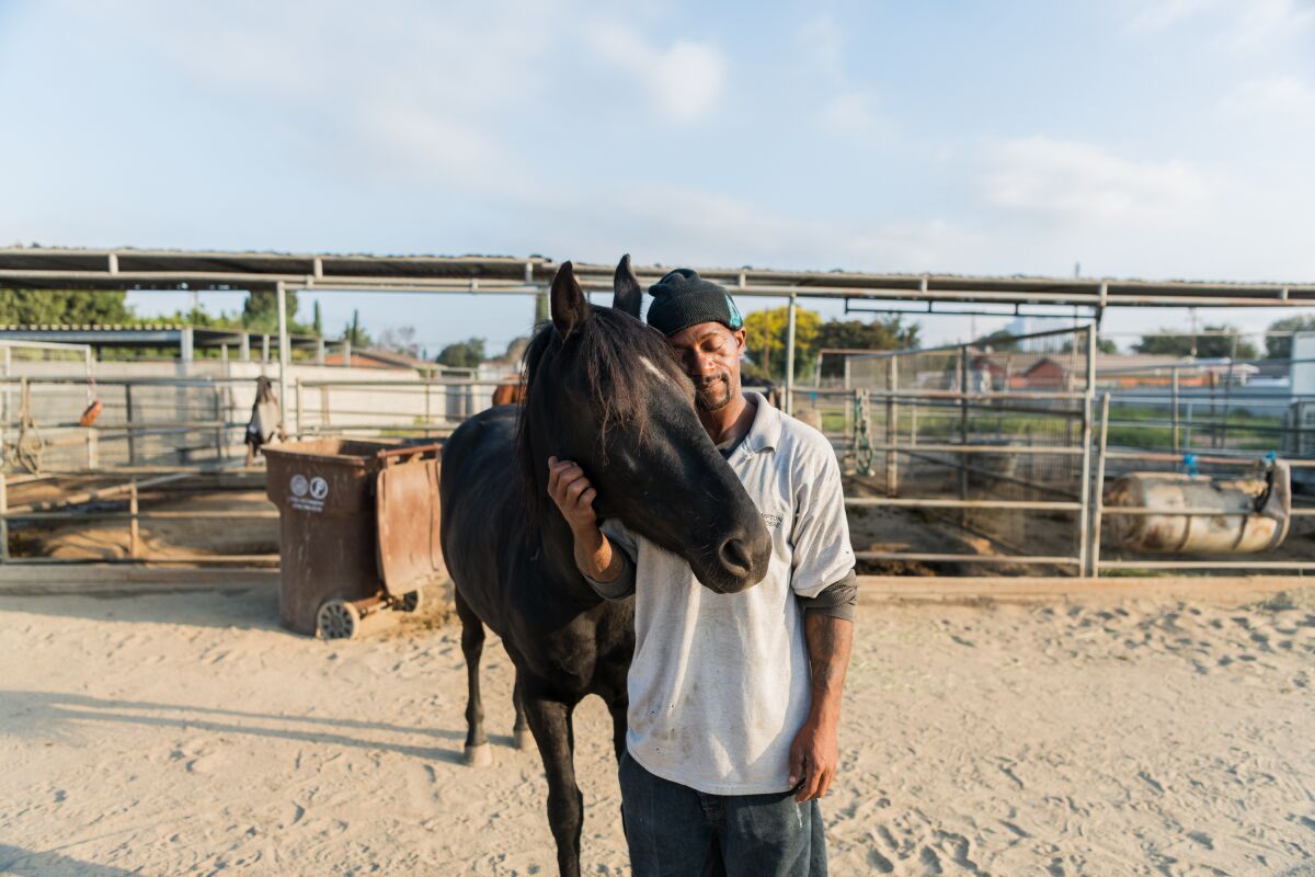 Anthony, a member of the Compton Cowboys, is having a moment with his horse, Dakota, on the Richland Farms ranch. 