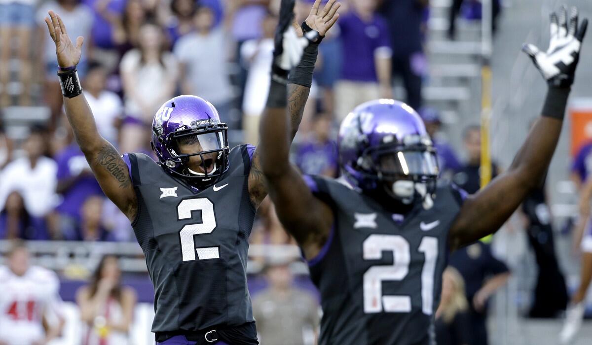 Texas Christian quarterback Trevone Boykin (2) and running back Kyle Hicks (21) celebrate after the Horned Frogs scored one of several touchdowns against Texas Tech on Saturday.
