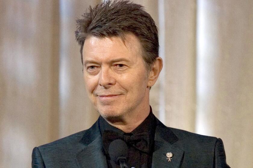 FILE - David Bowie accepts the lifetime achievement award at the 11th Annual Webby Awards in New York on June 5, 2007. The extensive catalog of David Bowie, stretching from the late 1960s to just before his death in 2016, has been sold to Warner Chappell Music. More than 400 songs, among them “Space Oddity,” “Ziggy Stardust," and “Let’s Dance" are included. (AP Photo/Stephen Chernin, File)