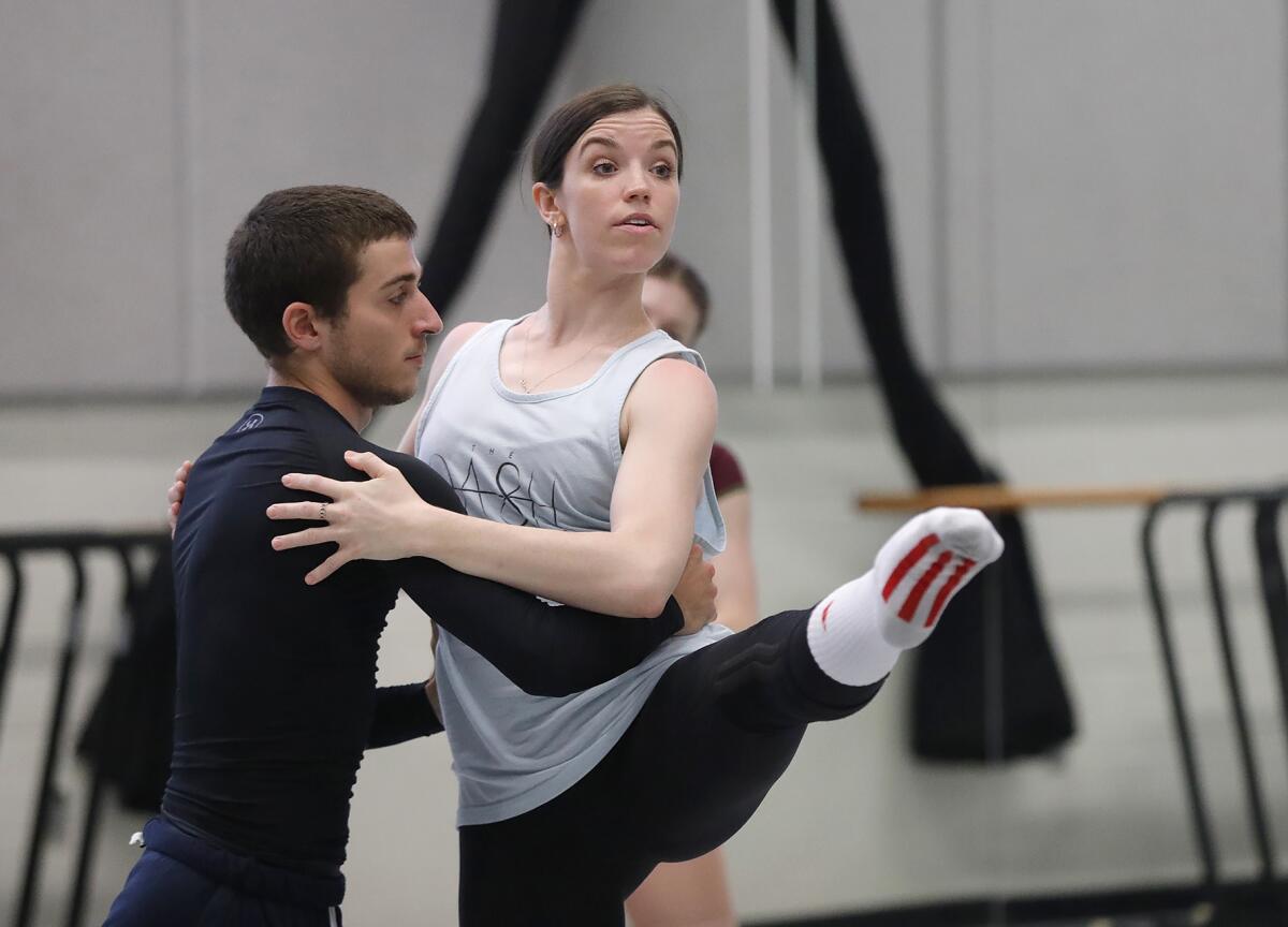 Choreographer Carrie Ruth Trumbo, right, works with dancer Cameron Pelton, left.