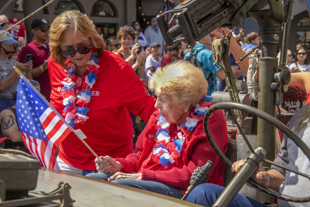 World War II veteran Doris Zavala is greeted by an admirer during the Huntington Beach Fourth of July Parade.