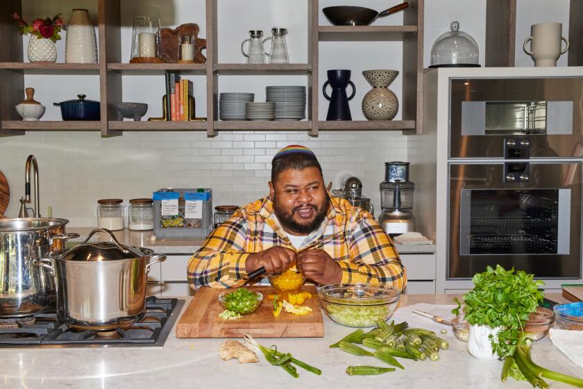 LOS ANGELES, CA - APRIL 1: Chef Michael Twitty cuts vegetables for his okra gumbo, featured in his cookbook KosherSoul, in the Los Angeles Times Test Kitchen on Monday, April 1, 2024.