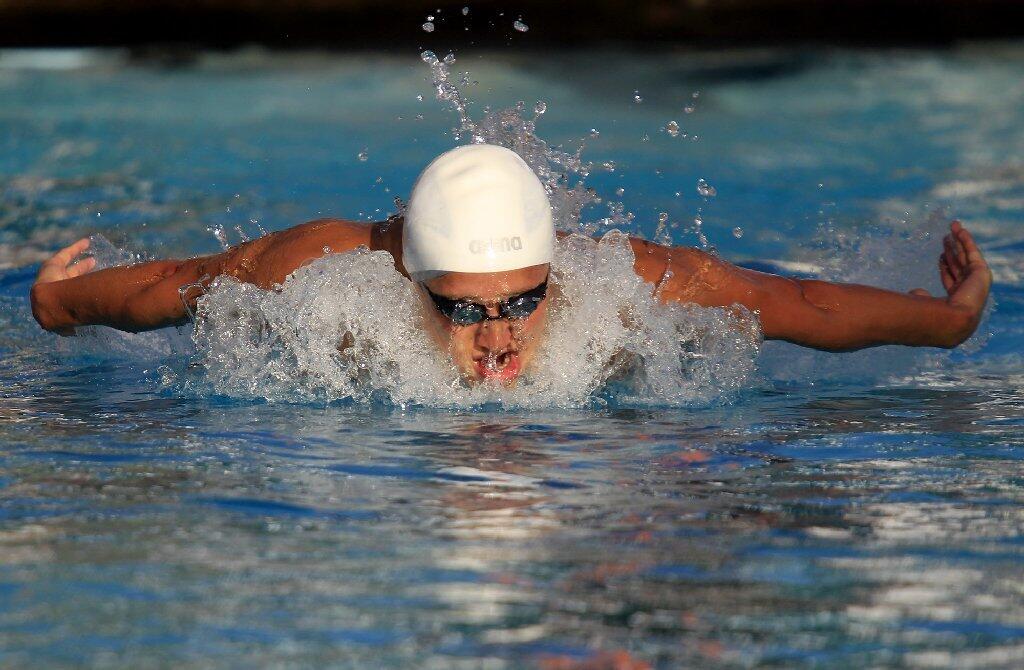 Corona del Mar High's Justin Hanson competes in the consolation final for the boys' 100-yard butterfly during the CIF Southern Section Division 1 finals at Riverside Community College on Saturday.