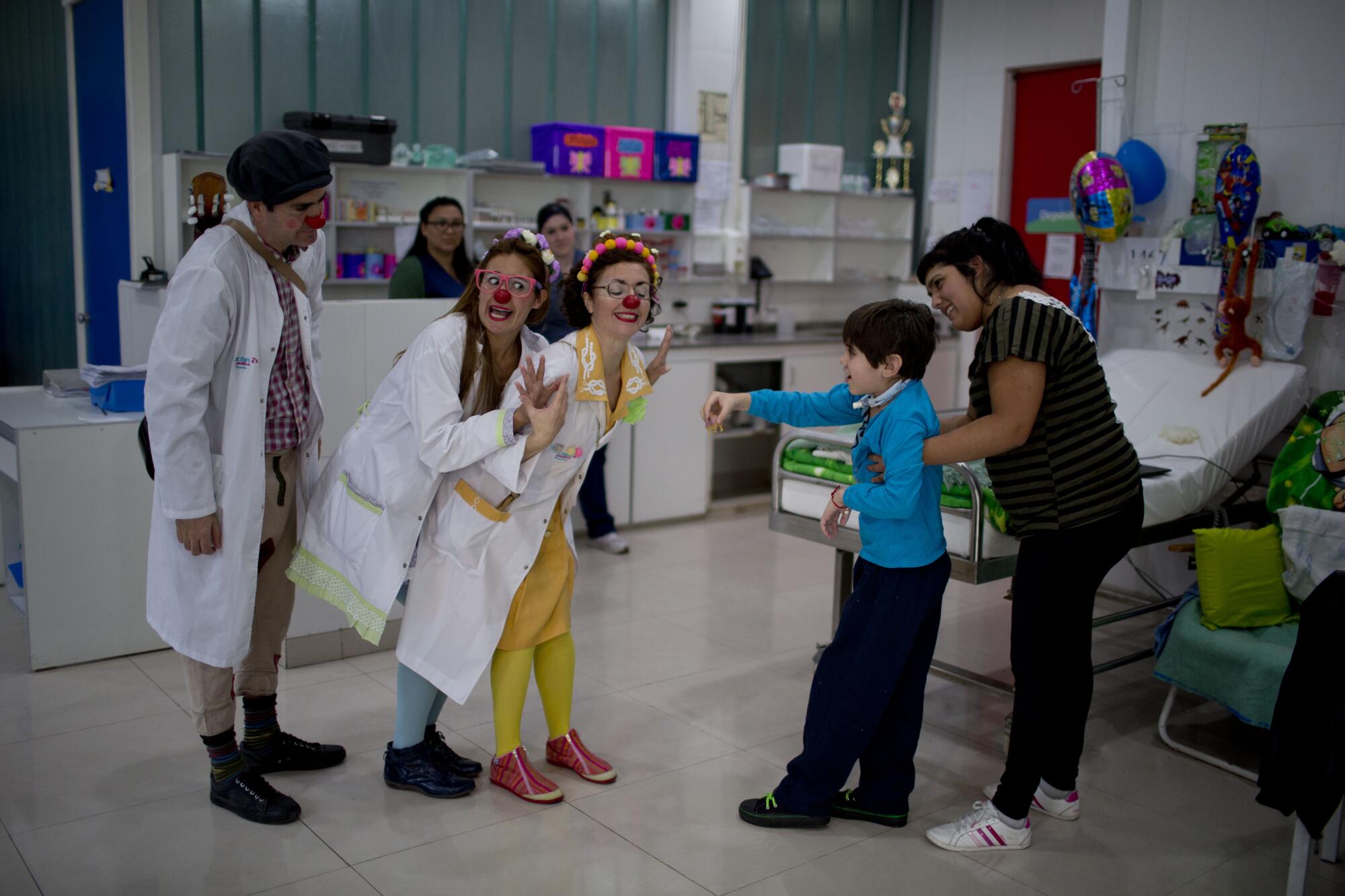 Clowns perform for Alejo Lacone at a pediatric hospital in Buenos Aires in 2015.