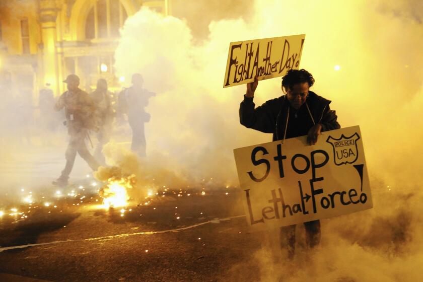 A protester flees from tear gas during this year's rioting in Baltimore. The federal government denied Maryland's request for disaster aid to assist in post-riot recovery. The governor is appealing the decision.