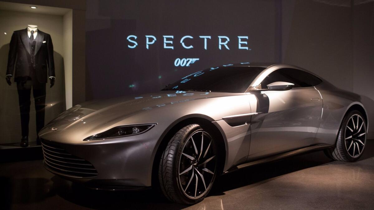 An Aston Martin DB10, produced exclusively for the James Bond film "Spectre," and a James Bond costume are displayed at the London Film Museum.