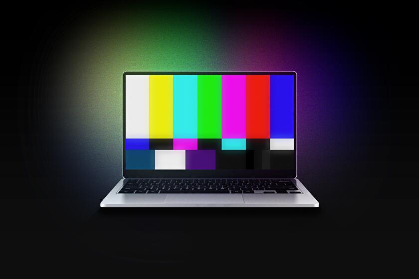 A laptop computer screen glows with the colors of the SMPTE color bars