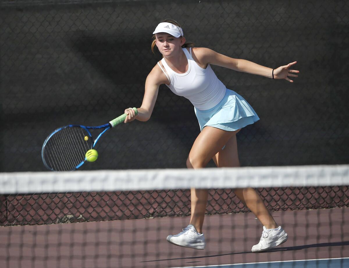 Corona del Mar singles player Polina Briggs hits a forehand return in her match against Laguna Beach on Thursday.