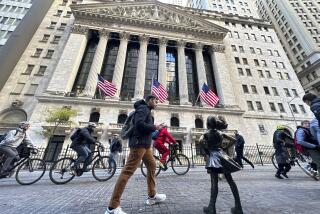 A man passes the "Fearless Girl" statue in front of the New York Stock Exchange in New York on Friday, November 3, 2023. Shares opened lower in Europe after a mixed day in Asia on Tuesday as investors waited for updates on inflation and how American consumers are feeling about the economy. (AP Photo/Ted Shaffrey)