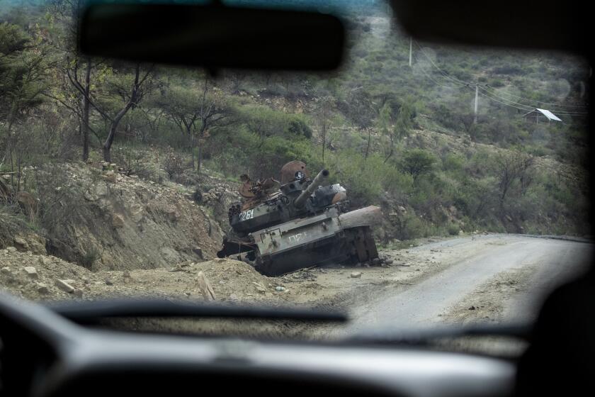 FILE - In this Tuesday, May 11, 2021 file photo, a destroyed tank sits by the side of a road leading to Abi Adi, in the Tigray region of northern Ethiopia. Ethiopia's government said in a statement carried by state media Monday, June 28, 2021, that it has "positively accepted" a call for an immediate, unilateral cease-fire in its Tigray region after nearly eight months of deadly conflict. (AP Photo/Ben Curtis, File)