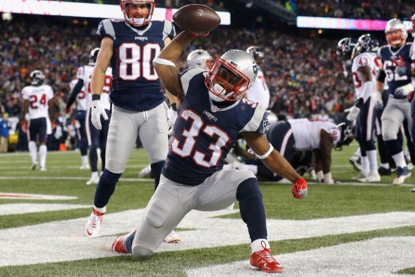 Patriots running back Dion Lewis celebrates after scoring a touchdown against the Texans during a game on Jan. 14.