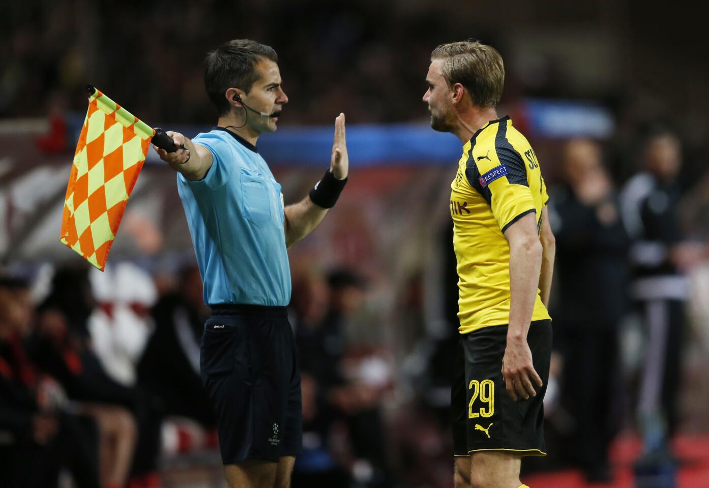 Borussia Dortmund's Marcel Schmelzer remonstrates with the assistant referee