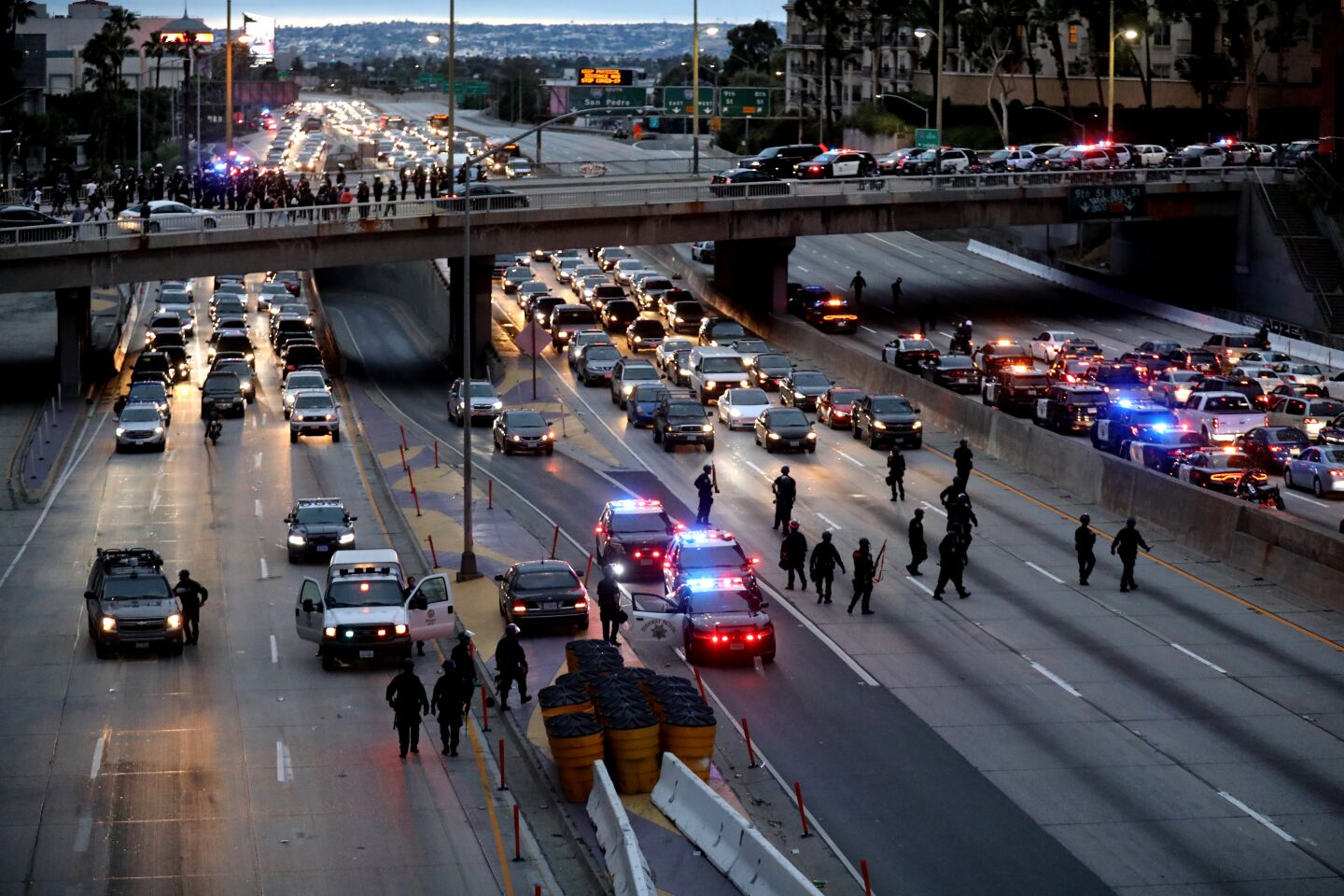 Los Angeles police patrol the 110 after having moved protesters off the freeway.