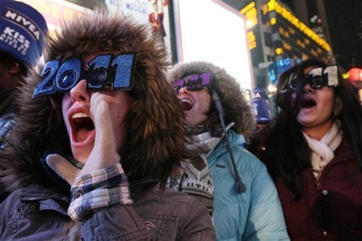 Shae Moxley, left, from Ashburn, Va., and others take part in the New Year's Eve festivities in New York's Times Square Friday Dec. 31, 2010. (AP Photo/Tina Fineberg)