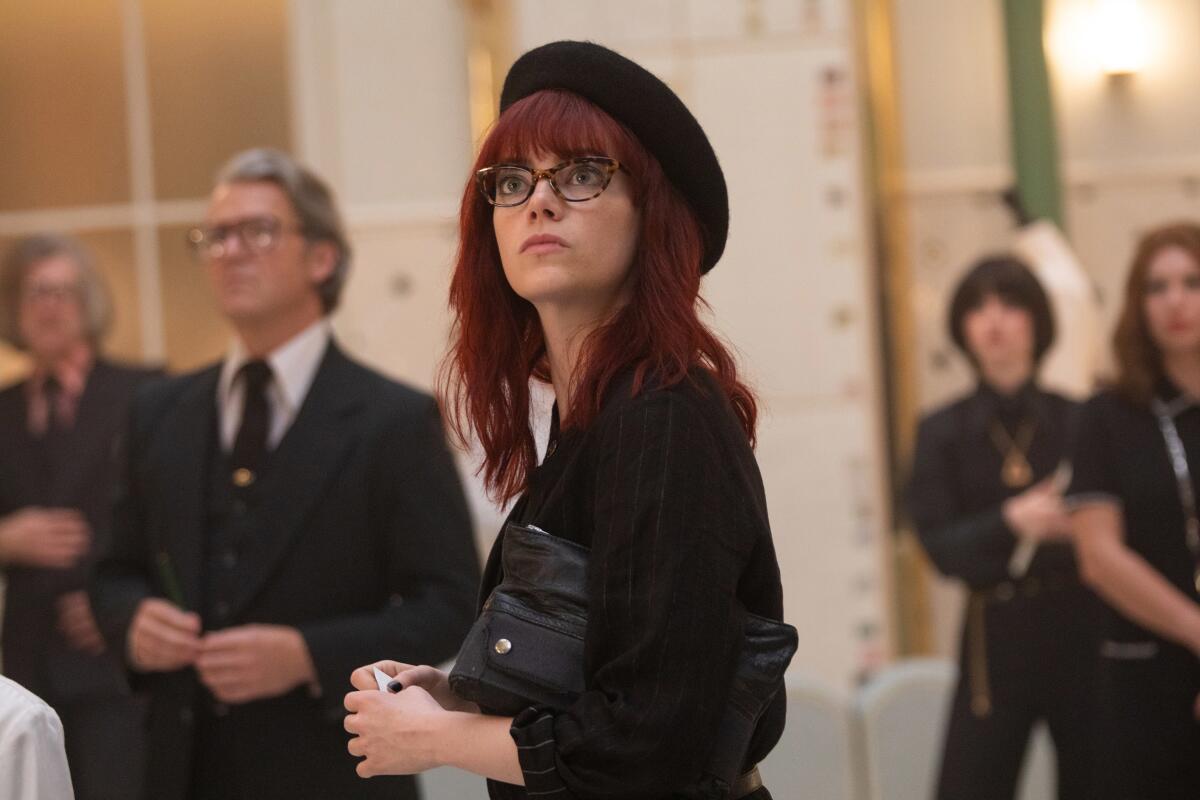 Emma Stone, in red hair and beret, in "Cruella."