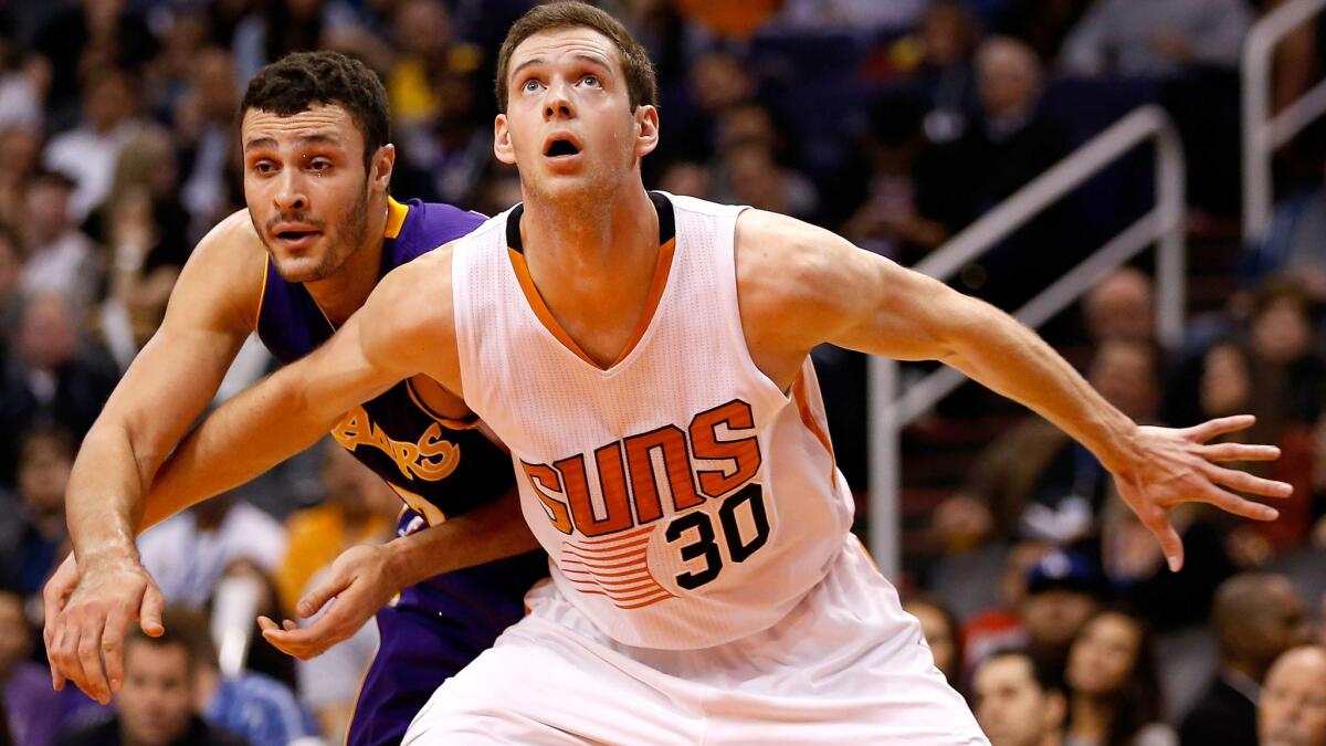 Lakers forward Larry Nance Jr. fights for rebounding position against Suns forward Jon Leuer during their game Nov. 16.