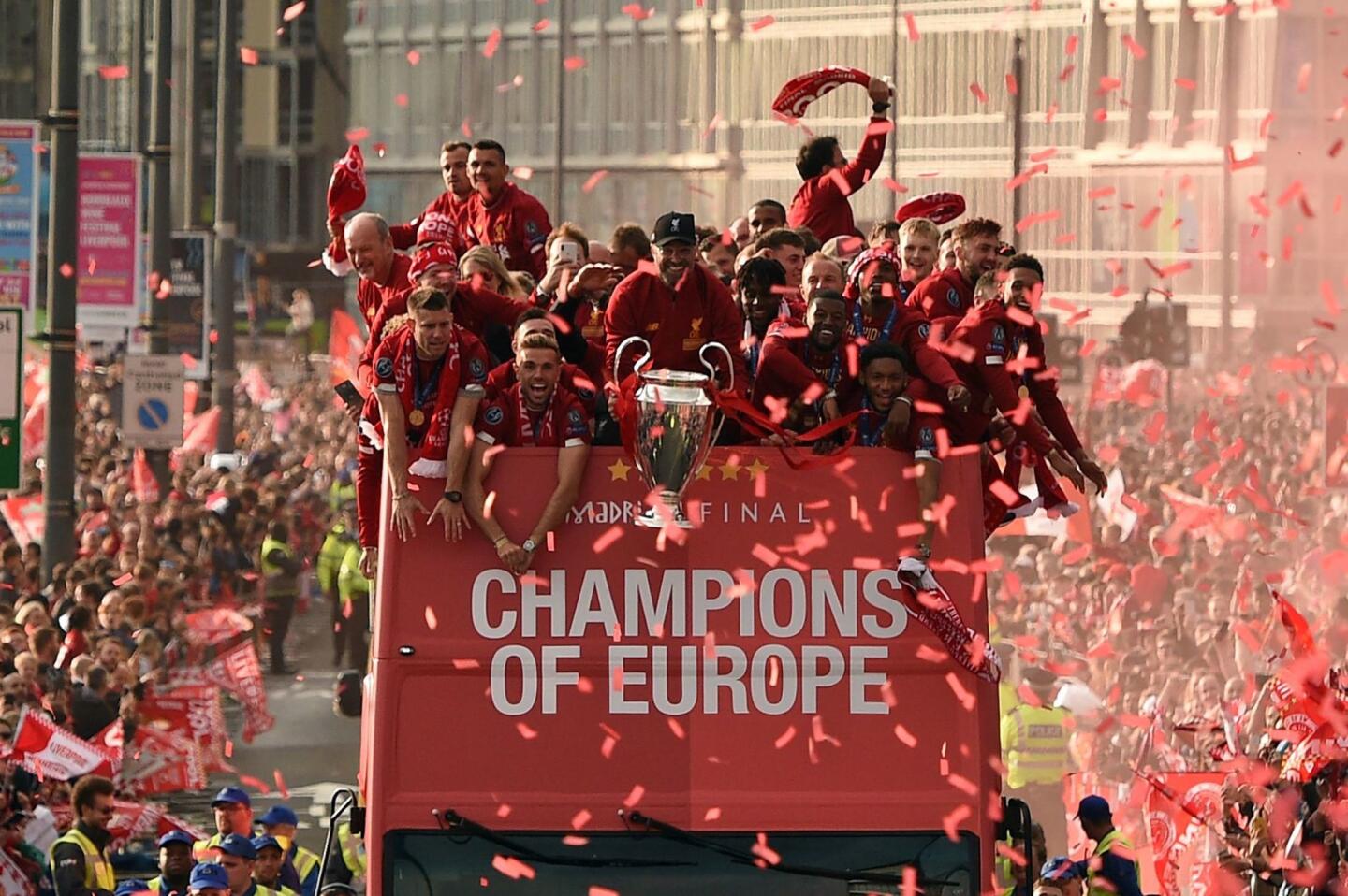 Liverpool's German manager Jurgen Klopp (C) holds the European Champion Clubs' Cup trophy during an open-top bus parade around Liverpool, north-west England on June 2, 2019, after winning the UEFA Champions League final football match between Liverpool and Tottenham. - Liverpool's celebrations stretched long into the night after they became six-time European champions with goals from Mohamed Salah and Divock Origi to beat Tottenham -- and the party was set to move to England on Sunday where tens of thousands of fans awaited the team's return. The 2-0 win in the sweltering Metropolitano Stadium delivered a first trophy in seven years for Liverpool, and -- finally -- a first win in seven finals for coach Jurgen Klopp. (Photo by Oli SCARFF / AFP)OLI SCARFF/AFP/Getty Images ** OUTS - ELSENT, FPG, CM - OUTS * NM, PH, VA if sourced by CT, LA or MoD **