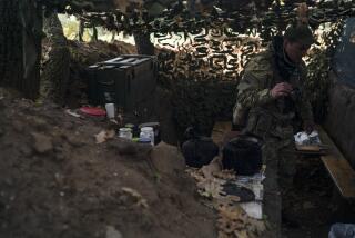 A Ukrainian serviceman checks the trenches dug by Russian soldiers in a retaken area in Kherson region, Ukraine, Wednesday, Oct. 12, 2022. (AP Photo/Leo Correa)