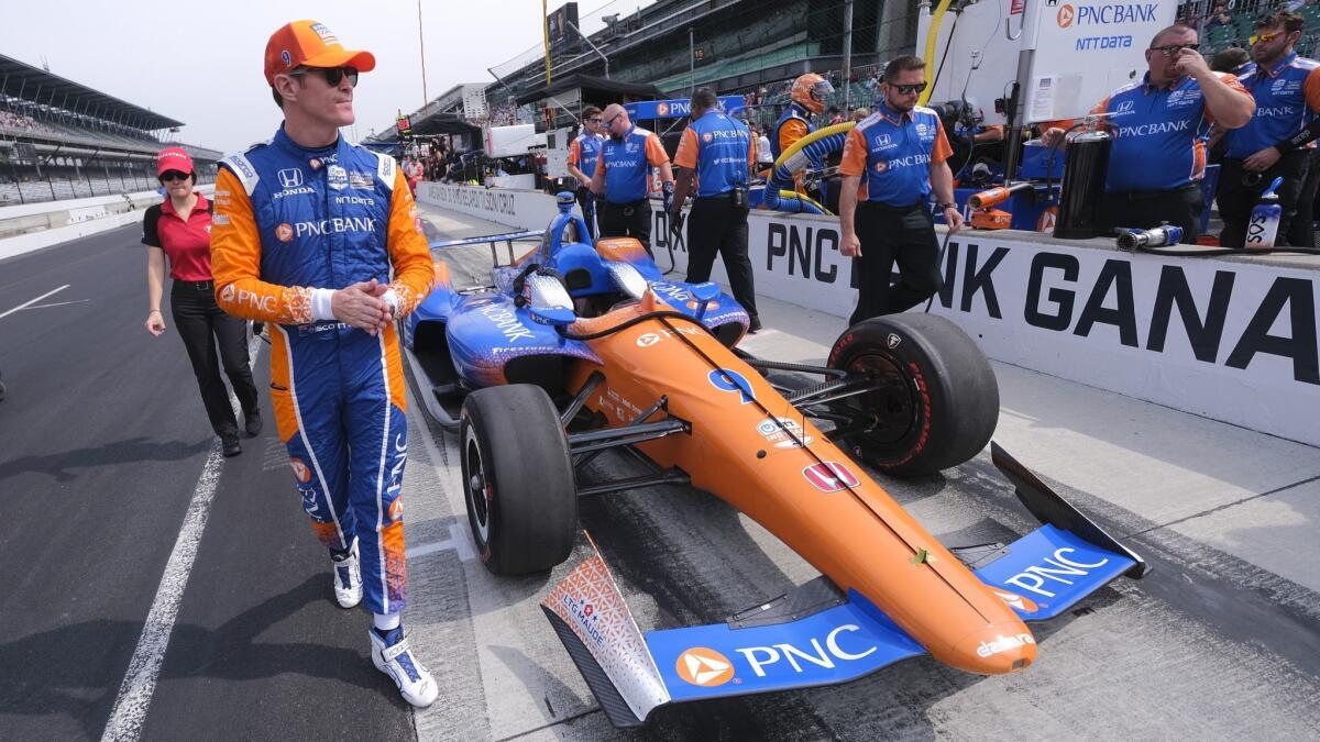 Scott Dixon, winner of the 2008 Indianapolis 500, walks around his car before the final practice session for this year's race on May 24 at Indianapolis Motor Speedway.