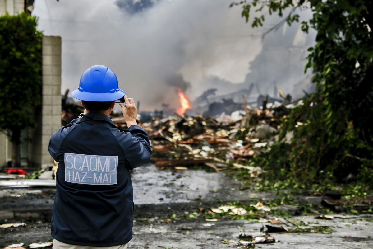 Larry Israel, from SCAQMD Hazmat, surveys the explosive June 14 fire at a Maywood warehouse.