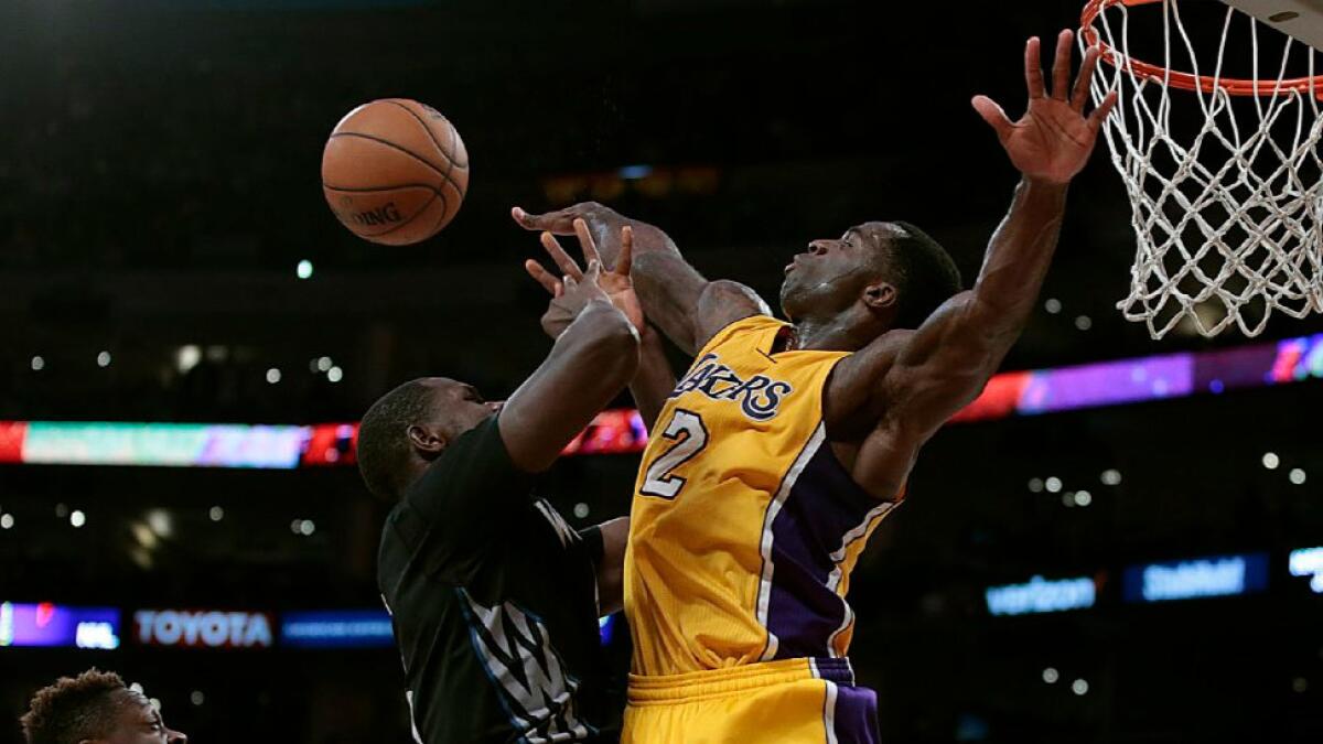 Lakers forward Brandon Bass gets called for a foul on Minnesota forward Gorgui Dieng during a game on Feb. 2.