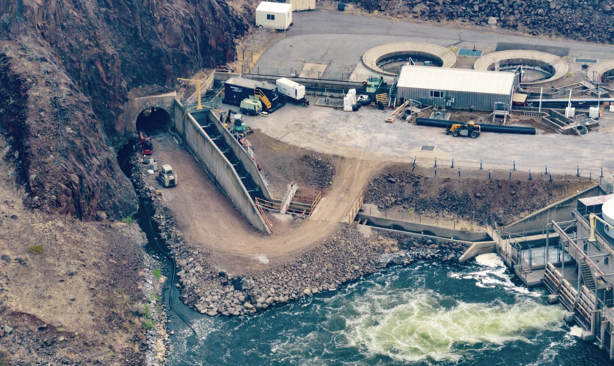 An aerial view of work along a dam. 