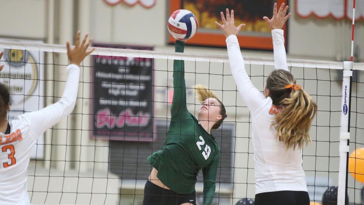 Edison High's Nikki Logan, shown hitting the ball against Huntington Beach on Oct. 9, helped the Chargers beat the Oilers on Wednesday, setting up a match for second place in the Surf League with Los Alamitos.
