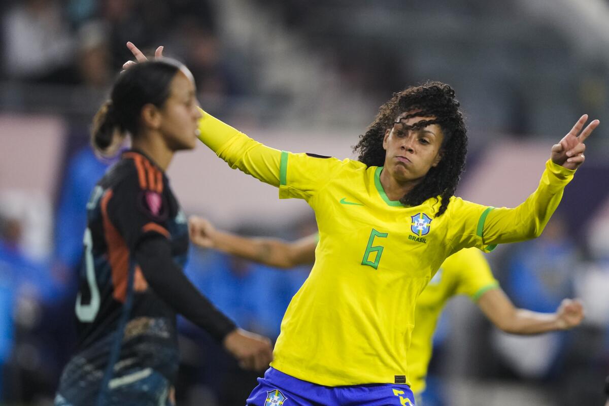 Brazil defender Yasmim, right, celebrates her goal.