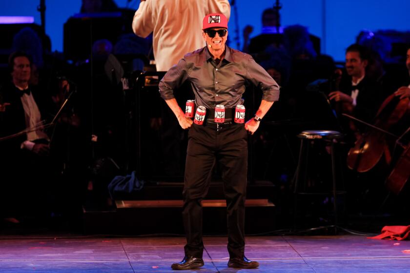 Actor Hank Azaria on stage Friday as "Duffman," in "The Simpsons Take the Bowl" concert at the Hollywood Bowl.