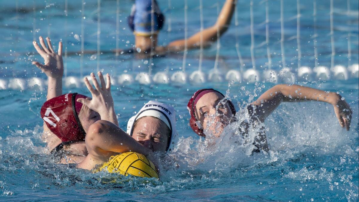 Laguna Beach High's Lela McCarroll, left, and Bryn Gioffredi, right, battle with Newport Harbor's Linnea Kelly in the quarterfinals of the Holiday Cup on Friday.
