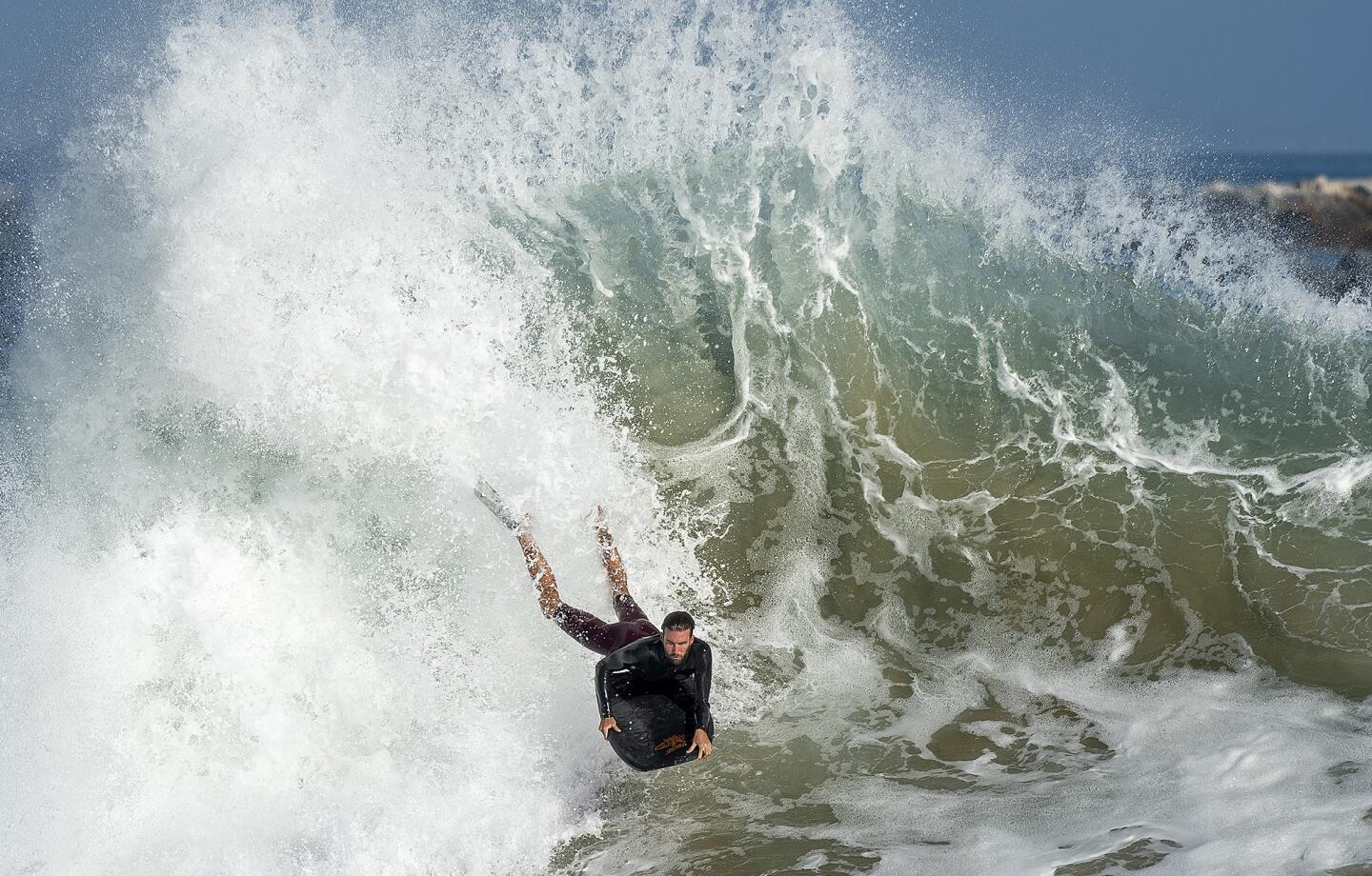 A bodyboarder drops into a wave at the Wedge in Newport Beach on Monday.