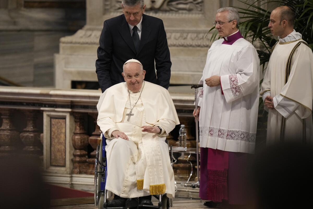 Pope Francis leaving St. Peter's Basilica in a wheelchair.