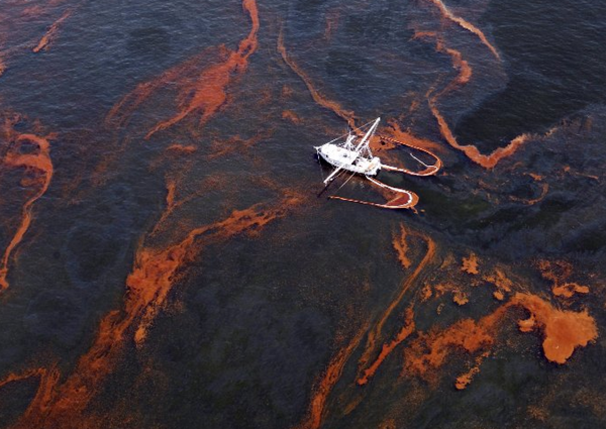 A shrimp boat helps collect oil after the 2010 spill in the Gulf of Mexico. A civil trial is set to begin this week with billions at stake for oil giant BP and Gulf states affected by the spill.