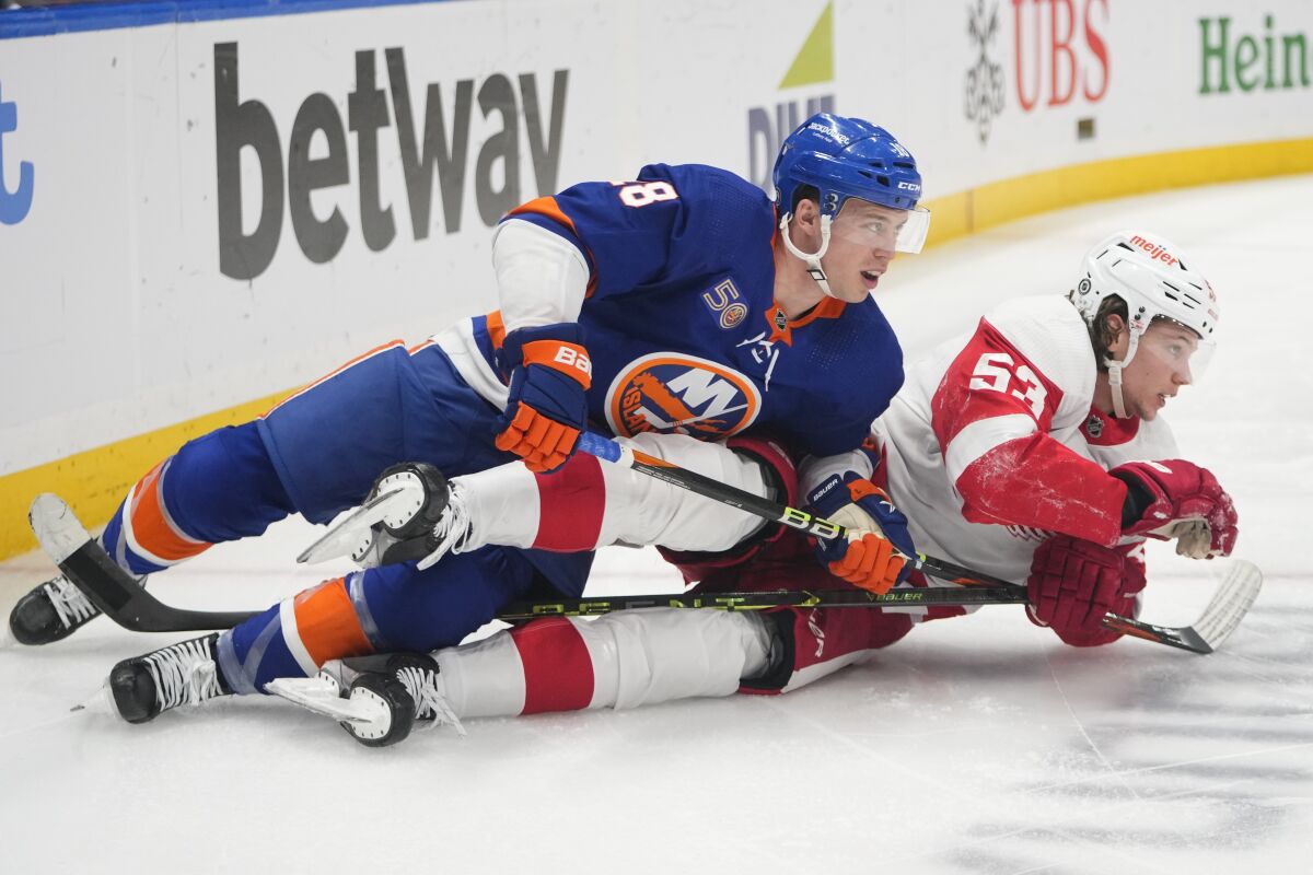 New York Islanders' Anthony Beauvillier (18) and Detroit Red Wings' Moritz Seider (53) fall down while fighting for postion during the second period of an NHL hockey game Friday, Jan. 27, 2023, in Elmont, N.Y. (AP Photo/Frank Franklin II)