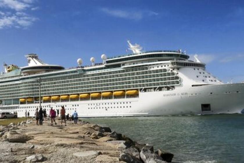 In this Monday, March 9, 2020 photo, Royal Caribbean's Mariner of the Seas departs Port Canaveral, Fla. On Friday, March 13, Royal Caribbean announced the suspension of all of their cruises worldwide for 30 days, in response to the coronavirus threat. (Joe Burbank/Orlando Sentinel via AP)