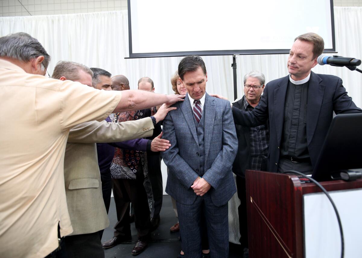 Local pastors pray for outgoing CEO Tyler Wright, center, at the YMCA of the Foothills annual Community Prayer Breakfast, in La Cañada Flintridge on Thursday, Nov., 7, 2019.