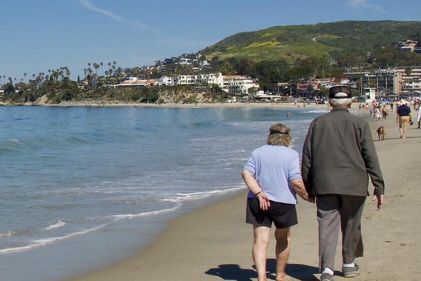 seniors walking on the beach