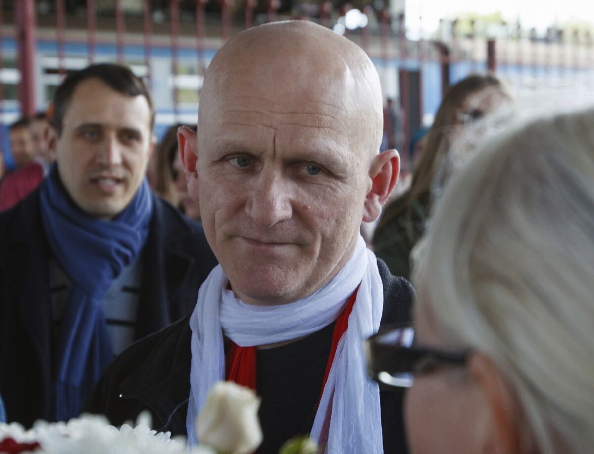 Human rights advocate Ales Bialiatski is welcomed by his supporters at a railway terminal in Minsk, Belarus, in 2014.