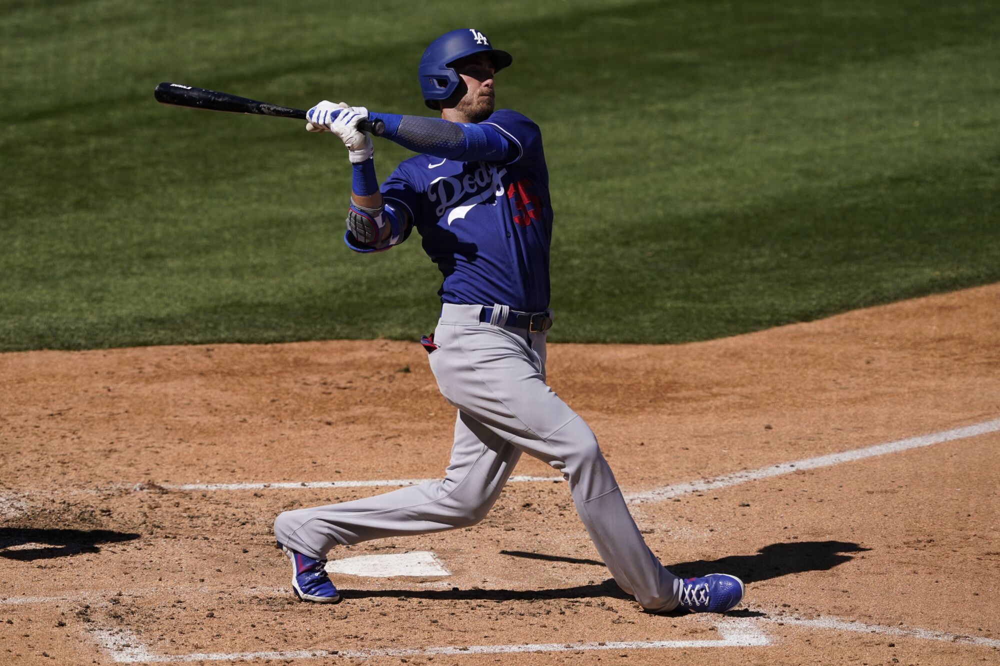 Dodgers center fielder Cody Bellinger bats against the Colorado Rockies in a spring training game.
