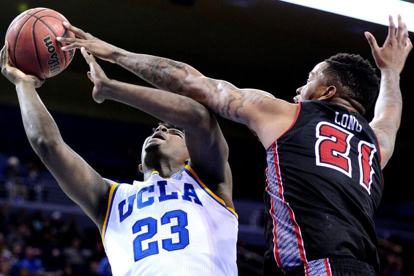 UCLA's Tony Parker has his shot blocked by Louisiana-Lafayette's Shawn Long at Pauly Pavillion on Tuesday.