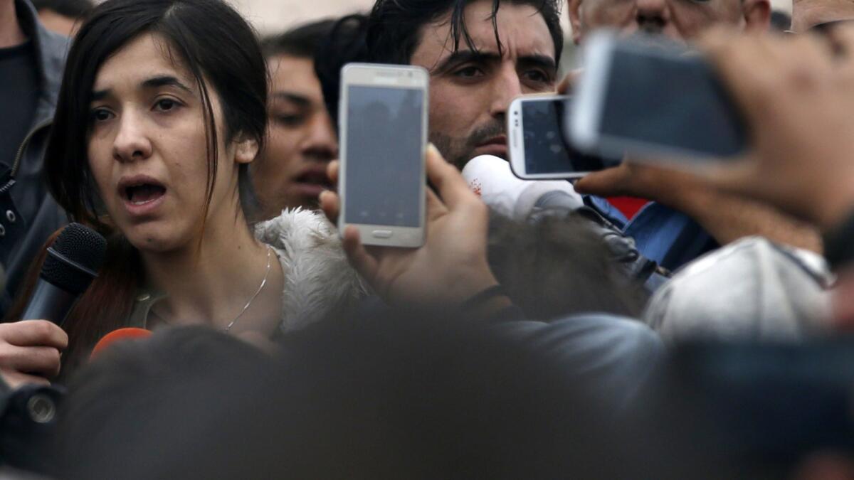 Nadia Murad, left, speaks during her 2016 visit in a makeshift refugee camp at the northern Greek border point of Idomeni, Greece. On Friday, the activist was awarded the Nobel Peace Prize.