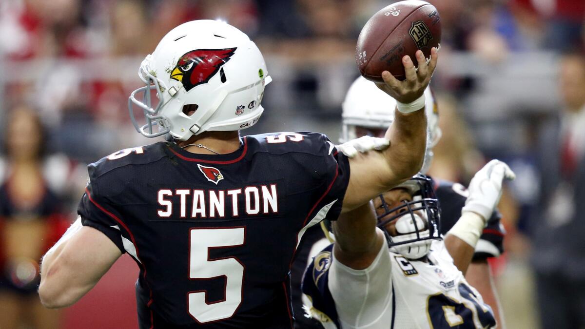 Rams tackle Aaron Donald hits the arm of Cardinals quarterback Drew Stanton as he attempts a pass in the second half.