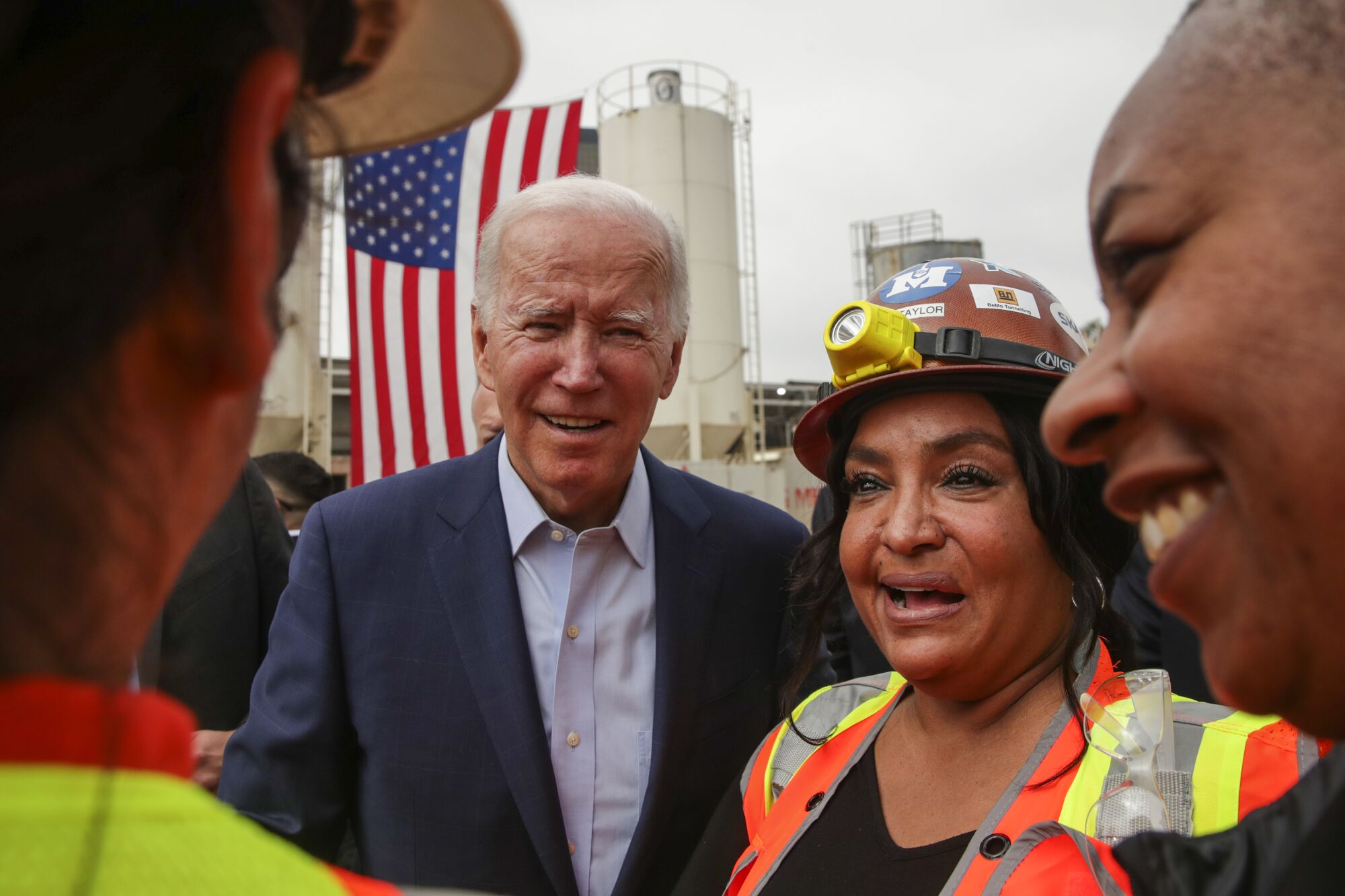 President Joe Biden chats with construction crew after visiting the site for the future terminus of the Metro D Line.