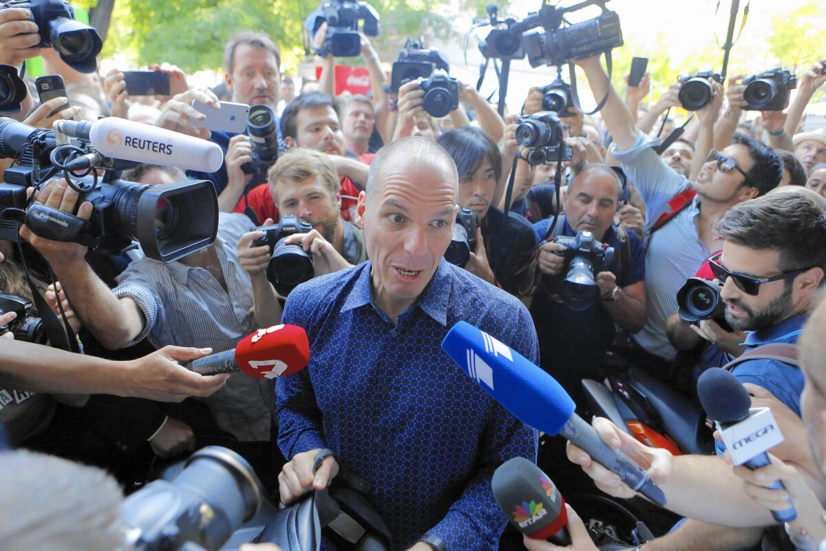 Outgoing Greek Finance Minister Yanis Varoufakis is surrounded as he tries to leave on his motorcycle after resigning in Athens. Greece and its membership in the Eurozone face an uncertain future after voters rejected a bailout plan that would have led to drastic austerity measures.