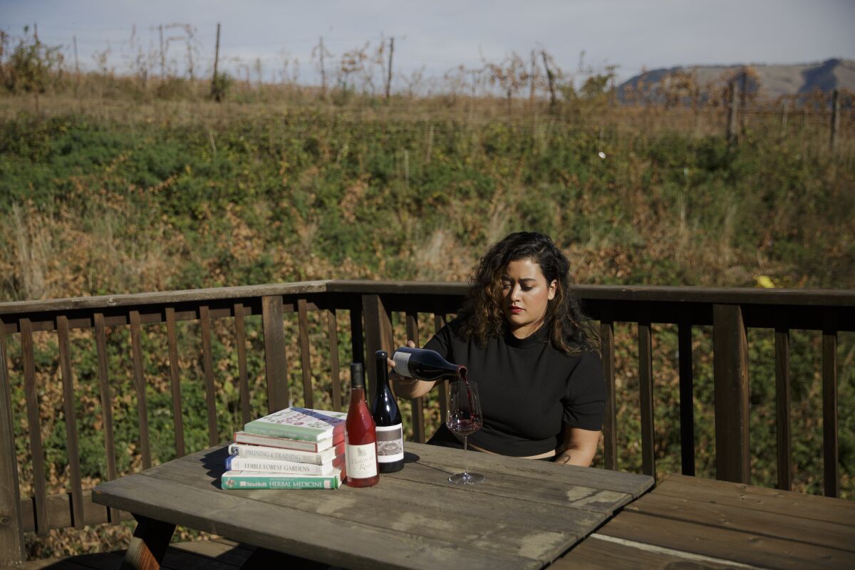 Jirka Jireh pours wine at a picnic table.