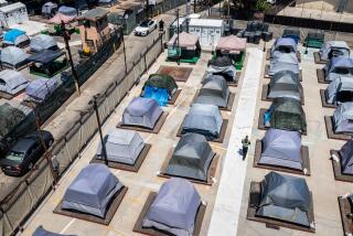 Los Angeles, CA - August 14: A drone's view of a visit to the Urban Alchemy homeless site, along South Central Avenue, in Los Angeles, CA, Monday, Aug. 14, 2023. Urban Alchemy, a San Francisco-based homeless services nonprofit, is exploring a form of homeless shelter where people live in tents for as long as they want, with no curfews and few rules and can recieve help applying for the support of a government-run program. The space has room for 90 people at capacity, housed in tents placed on palettes sitting several inches above the ground. (Jay L. Clendenin / Los Angeles Times)