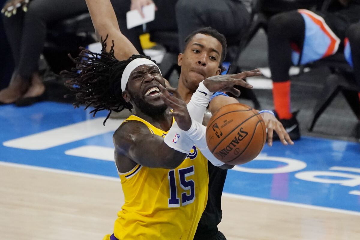 Lakers center Montrezl Harrell is fouled by Thunder center Moses Brown.