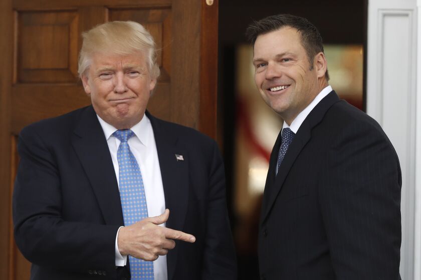 President-elect Donald Trump greets Kansas Secretary of State, Kris Kobach, as he arrive at the Trump National Golf Club Bedminster clubhouse, Sunday, Nov. 20, 2016, in Bedminster, N.J. (AP Photo/Carolyn Kaster)
