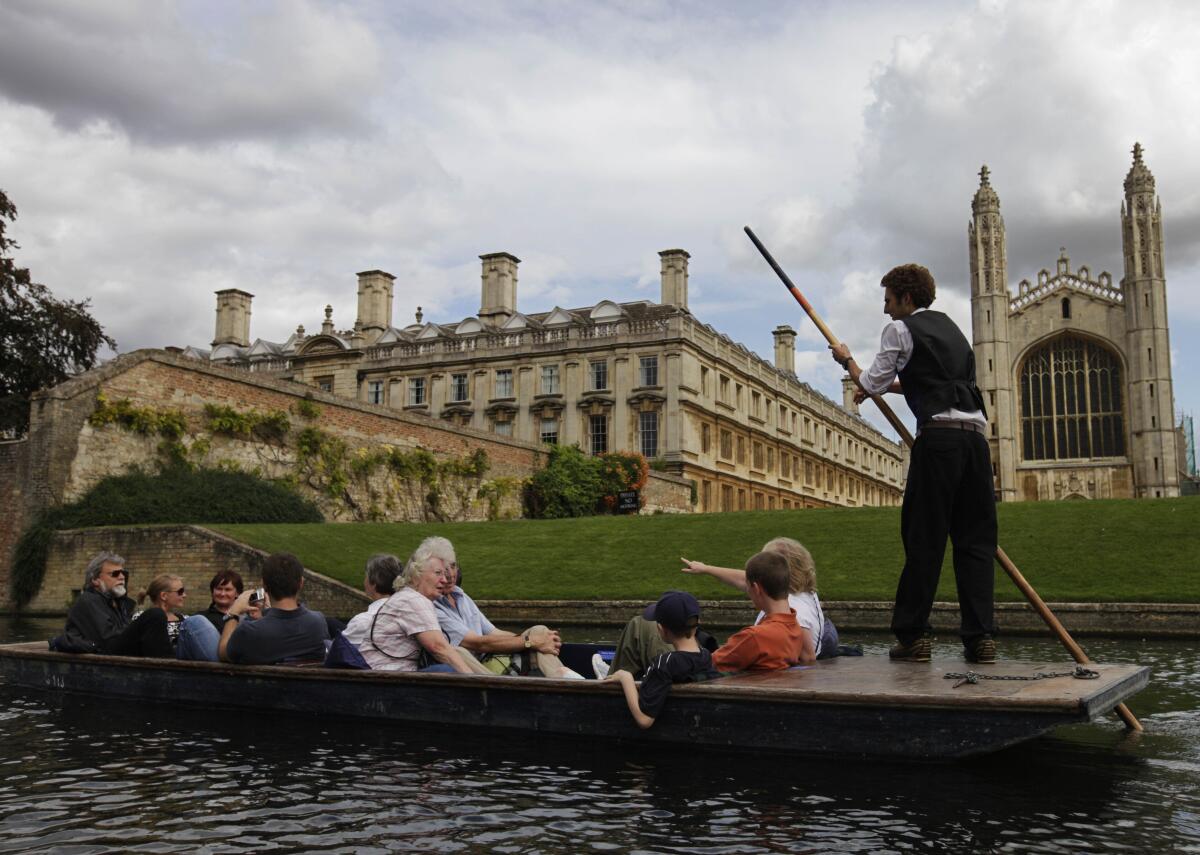 Tourists enjoy a boat ride on the river Cam, in Cambridge, England. 
