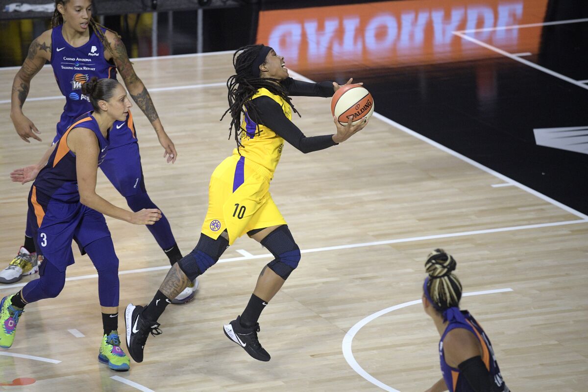 Sparks guard Tierra Ruffin-Pratt goes up for a shot in front of Phoenix Mercury guard Diana Taurasi.